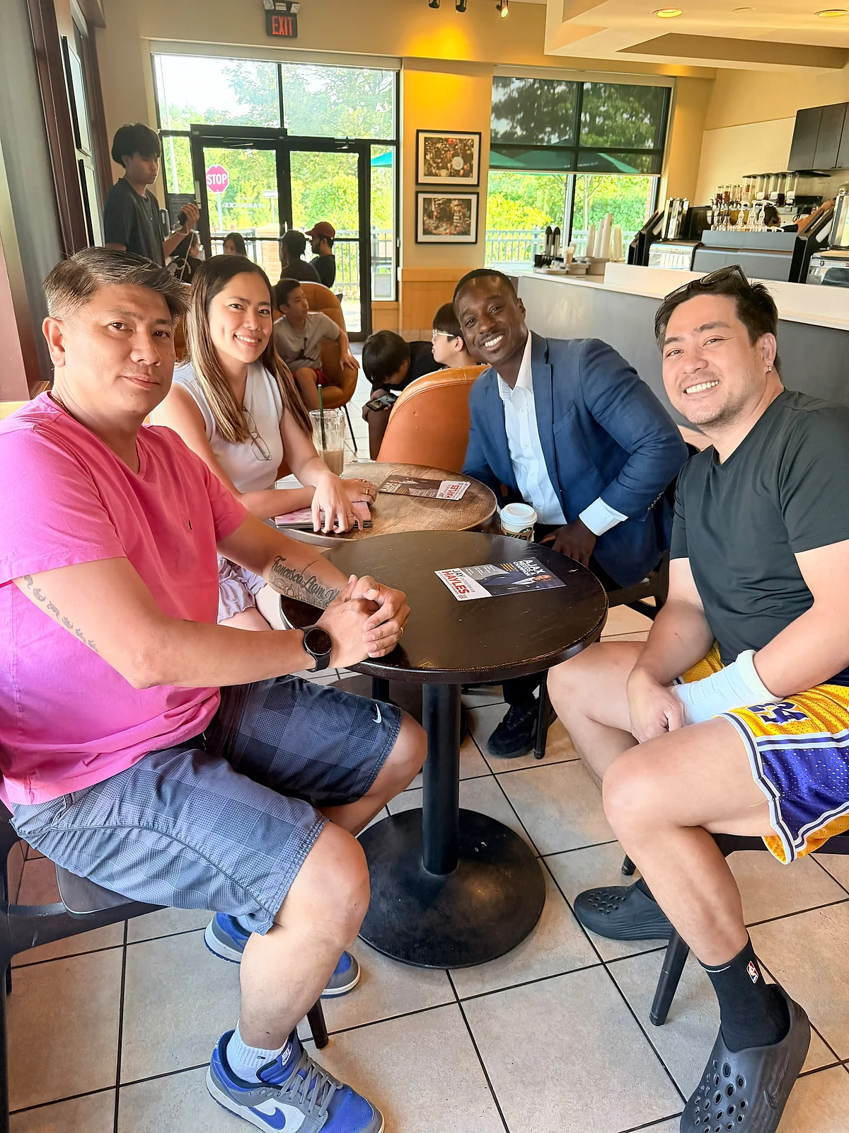 Jay Hayles sitting with a family in a Ward 2 café