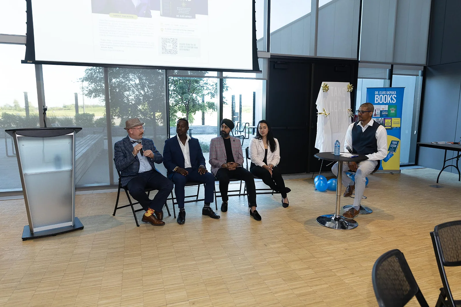 Jay Hayles seated on a panel at a community event