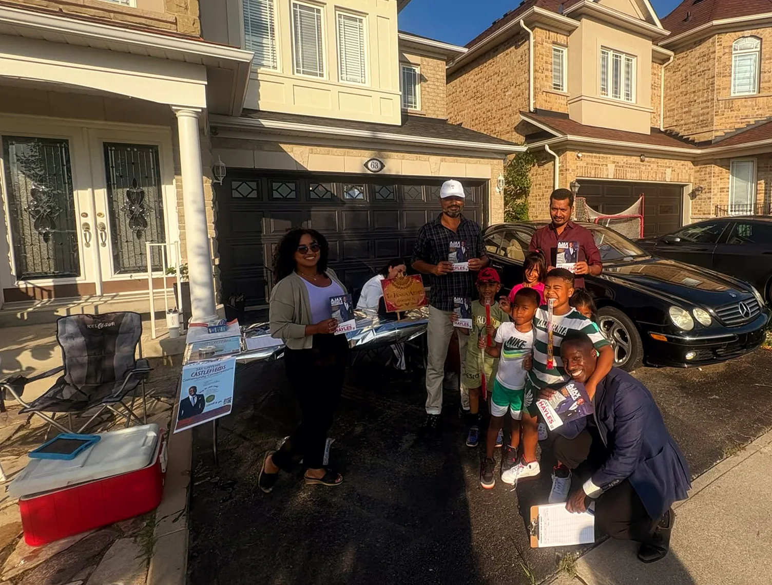 Jay Hayles with families at a driveway community event in Ward 2