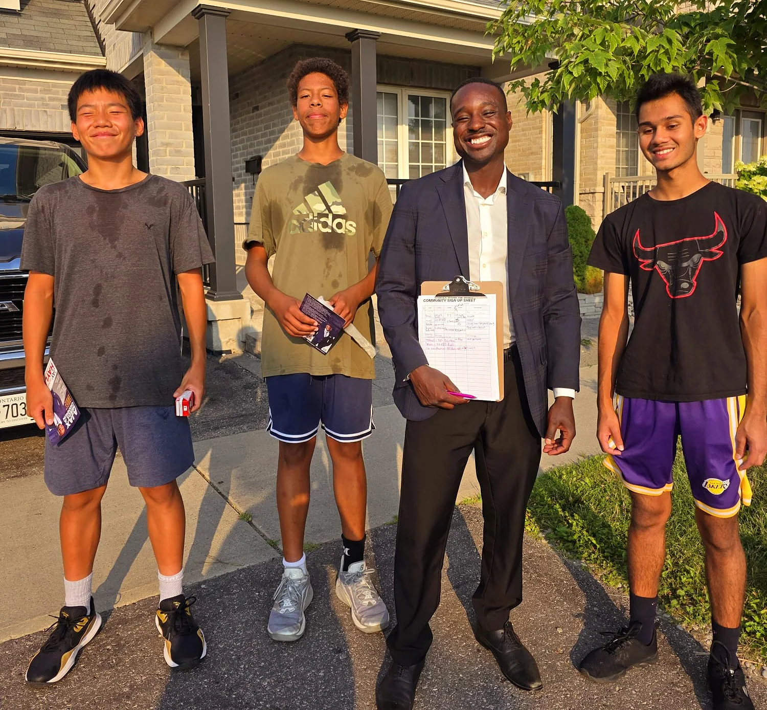 Jay Hayles talking with young residents on a Ward 2 driveway