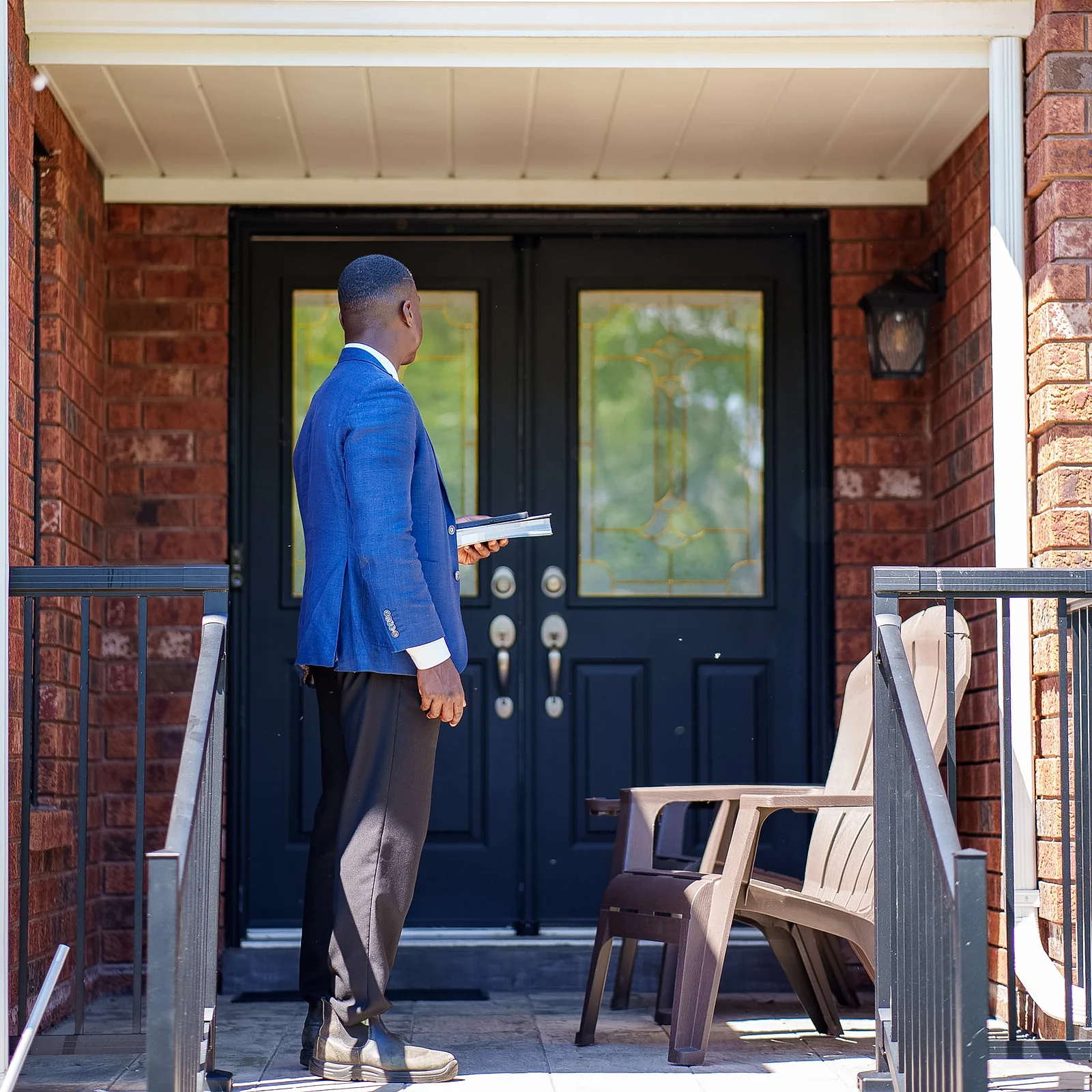 Jay Hayles at a Ward 2 front door with campaign literature in hand