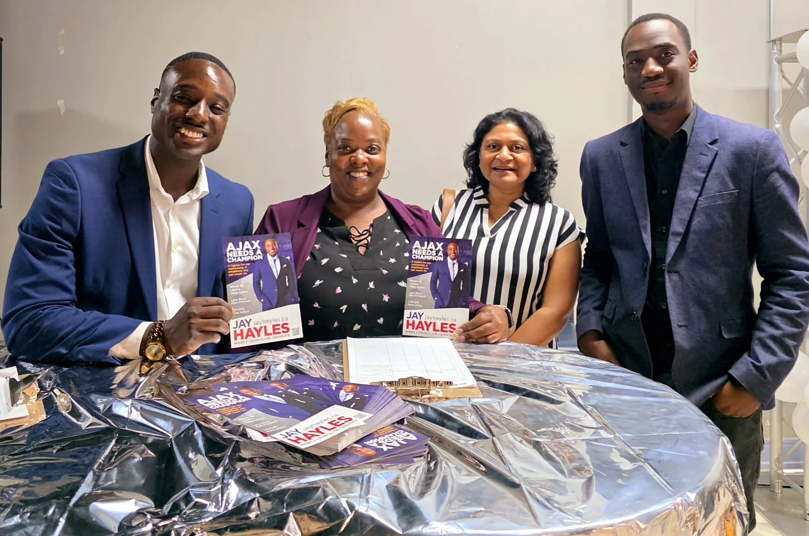 Jay Hayles with volunteers at a table of campaign literature